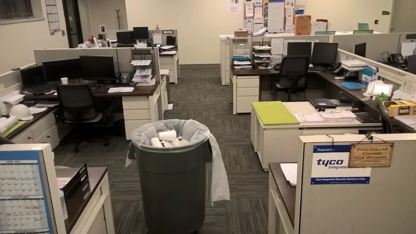DynamiClean emptying office trash bins during a commercial cleaning in Michigan
